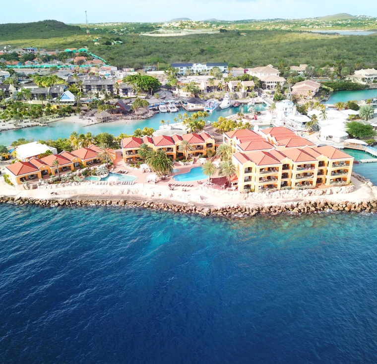 Natural leather mouse pad on white desk next to porcelain mug and keyboard.